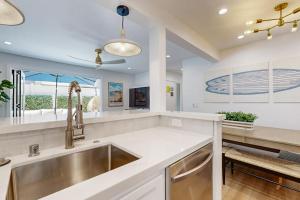 a kitchen with a sink and a counter top at Mickey's Hideaway in Anaheim +16 photos