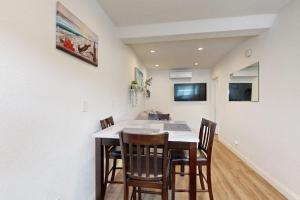 a dining room with a table and chairs at Fair Weather in Newport Beach