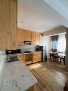 a kitchen with wooden cabinets and a counter top at Casa da Tá in Espargos
