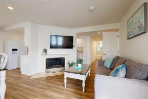 a living room with a couch and a fireplace at Sunny Days in Newport Beach