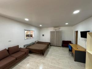 a living room with a bed and a desk at Finca Luz in Santiago del Estero