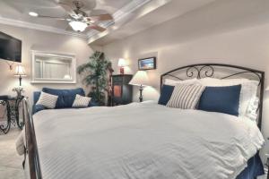 a bedroom with a large bed and a ceiling fan at San Clemente - Monterey D in San Clemente