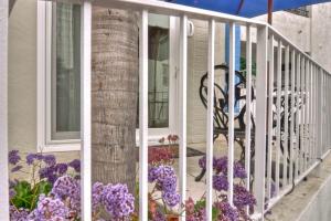 a balcony with purple flowers on a house at San Clemente - Monterey D in San Clemente