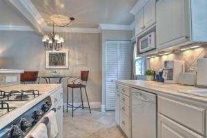 a kitchen with a stove top oven next to a table at San Clemente - Monterey B in San Clemente