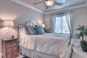 a bedroom with a bed and a ceiling fan at San Clemente - Monterey B in San Clemente +3 photos