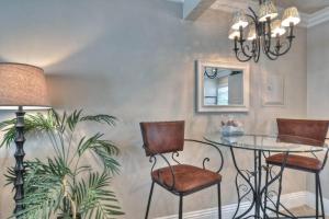 a dining room with a glass table and chairs at San Clemente - Monterey B in San Clemente
