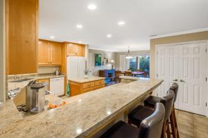 a kitchen with a counter and some chairs in it at Berry House in Arroyo Grande