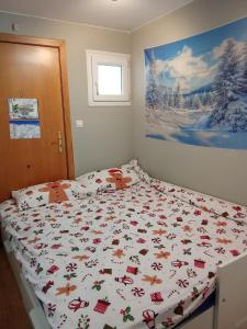 a bedroom with a bed with a christmas themed bedspread at Snow Dreams in Sierra Nevada
