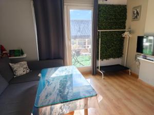 a living room with a glass table and a window at Snow Dreams in Sierra Nevada