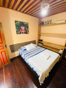 a bedroom with a bed with a painting on the wall at Casa Quietude - Manaus - Manacapuru in Manacapuru +105 photos