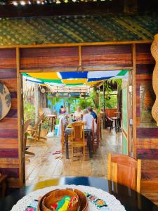 a group of people sitting at a table in a restaurant at Casa Quietude - Manaus - Manacapuru in Manacapuru