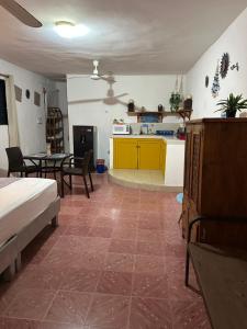 a living room with a bed and a kitchen at San Miguel 2 in Cozumel