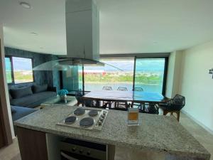 a kitchen with a counter top and a table in a room at Departamento en el malecón, Torre Central 102 in Mazatlán