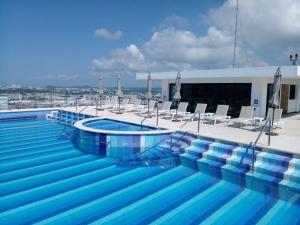 a swimming pool on the roof of a building at Departamento en el malecón, Torre Central 102 in Mazatlán