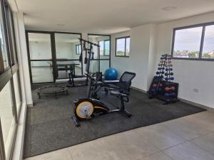a fitness room with a gym with exercise equipment at Apartamento com Piscina Rooftop e Hidro perto do Centro e da Praia, Porto Blue Porto de Galinhas in Porto De Galinhas