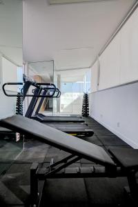 a gym with several treadmills in a room at Rio Design Copacabana Hotel in Rio de Janeiro