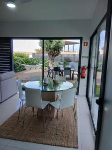 a dining room with a table and chairs at Casa das 3 Oliveiras in Porto Santo