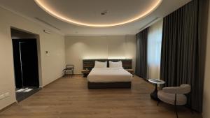 a hotel room with a bed and a circular ceiling at Mirada Purple Najran Hotel in Najran +99 photos