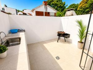 a kitchen with a sink on a white wall at San bernardo relax in San Bernardo