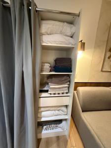 a room with a closet with a bed and towels at Le cœur du Panier in Marseille