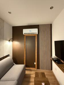 a living room with a bed and a window and a television at Le cœur du Panier in Marseille