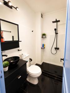 a black and white bathroom with a toilet and a sink at San bernardo relax in San Bernardo