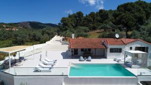 a villa with a swimming pool and a house at Villa Emerald Diamond in Kolios