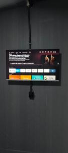 a flat screen tv hanging on a wall at City suítes hotel in Diamantino