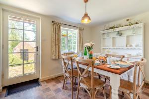 a dining room with a table and chairs and a window at 3 Bed in Dunwich oc-atc2 in Dunwich
