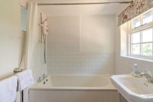 a white bathroom with a tub and a sink at 3 Bed in Dunwich oc-atc2 in Dunwich +18 photos