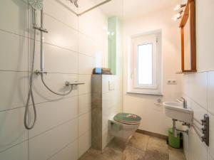 a bathroom with a shower and a toilet and a sink at Regenbogenhaus in Mayrhofen +24 photos