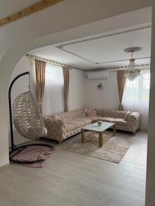 a living room with a couch and a table at Villa Noir Sarajevo in Sarajevo +14 photos