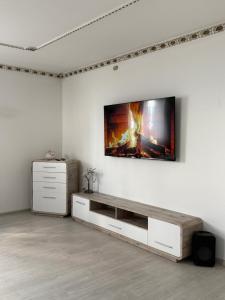 a living room with a flat screen tv on a wall at Villa Noir Sarajevo in Sarajevo