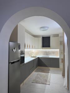 an archway in a kitchen with a refrigerator at Villa Noir Sarajevo in Sarajevo