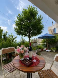 a table with a bottle of wine and flowers on it at Apartments Buena Vista in Ulcinj