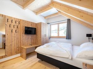 a bedroom with a bed and a tv on a wall at Steier Hütte in Donnersbachwald