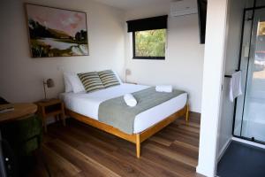 a bedroom with a bed and a window at Lake Colac Holiday Park in Colac
