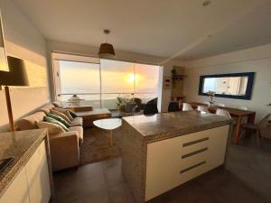 a kitchen and living room with a couch and a table at Beach view apartment Punta Hermosa 4BR in Punta Hermosa