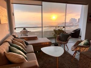 a living room with a couch and a view of the ocean at Beach view apartment Punta Hermosa 4BR in Punta Hermosa