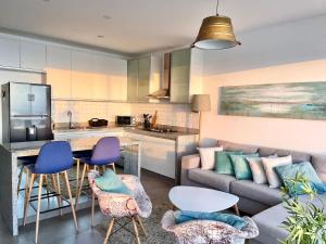 a living room with a couch and a kitchen at Beach view apartment Punta Hermosa 4BR in Punta Hermosa