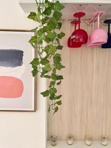 a green plant hanging from a wall with two lights at Beach view apartment Punta Hermosa 4BR in Punta Hermosa +15 photos