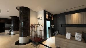 a lobby with a bird cage in a building at Mirada Purple Najran Hotel in Najran
