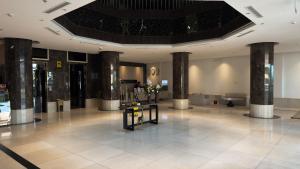 a lobby with columns in a building at Mirada Purple Najran Hotel in Najran