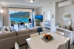 a living room with a couch and a table at Club Airlie in Airlie Beach