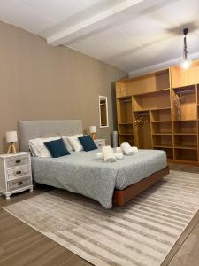 a bedroom with a large bed with blue pillows at Casa dos Andrés in Calheta