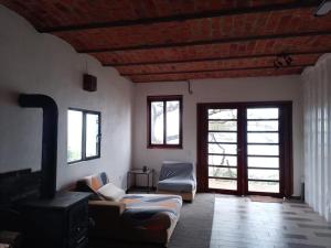 a living room with a couch and a wood stove at Off-grid mountain house with a view La Manchoza in Tapalpa