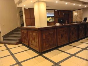 a hotel lobby with a reception counter and stairs at Hotel Rivoli in Mar del Plata