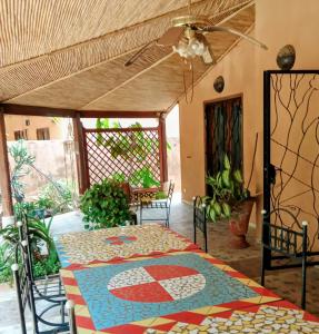 a patio with a table and chairs and a ceiling at VILLA Alia in Nianing