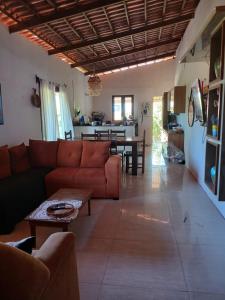 a living room with a couch and a table at Tigre Beach House in Trairi