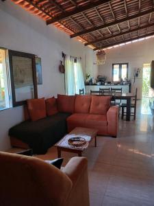 a living room with a couch and a table at Tigre Beach House in Trairi